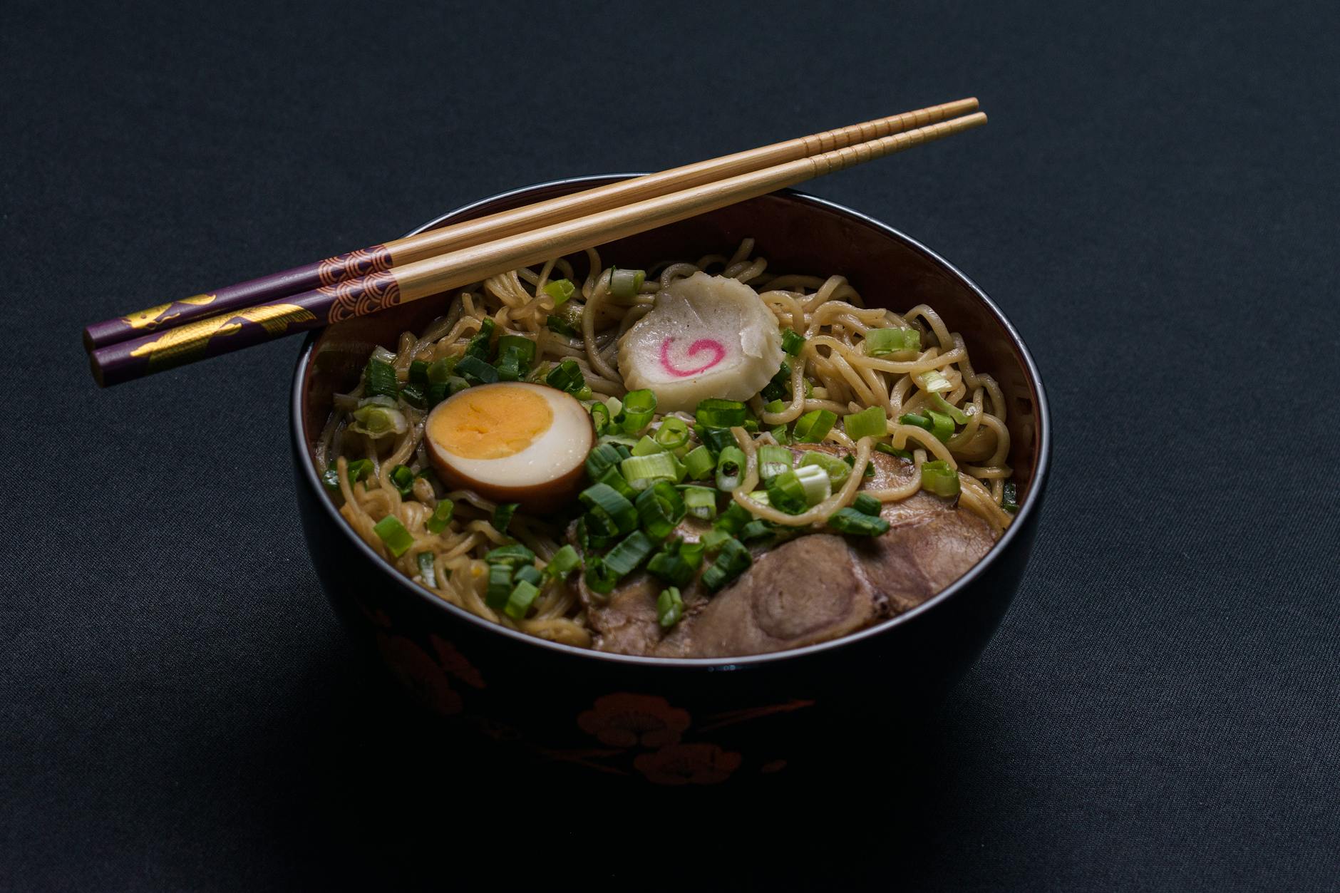 Ramen bowl with soft-boiled egg, spinach, and scallions