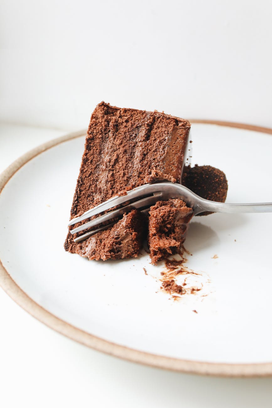Dense flourless chocolate cake slice with powdered sugar