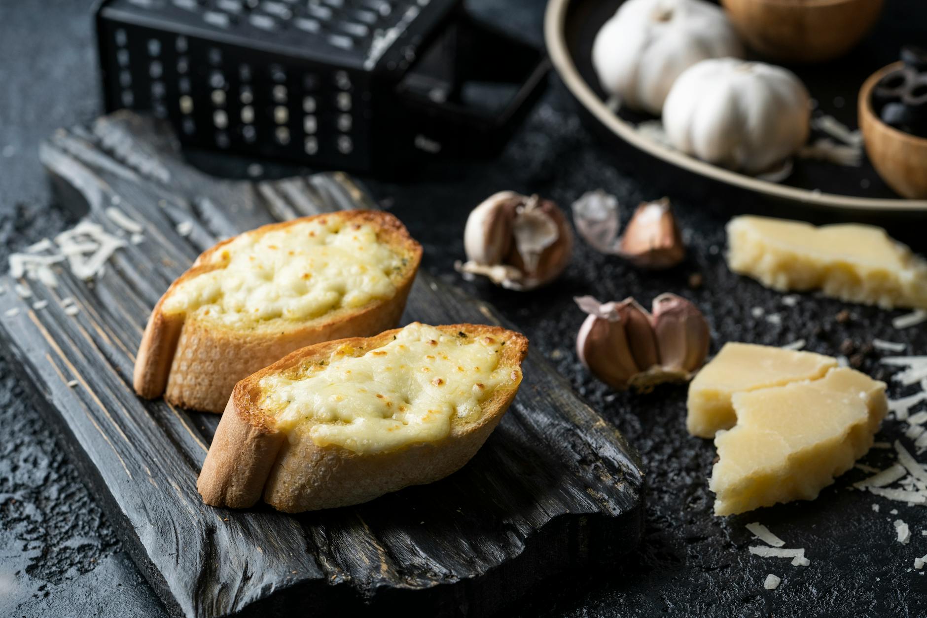 Golden garlic bread slices on a cutting board