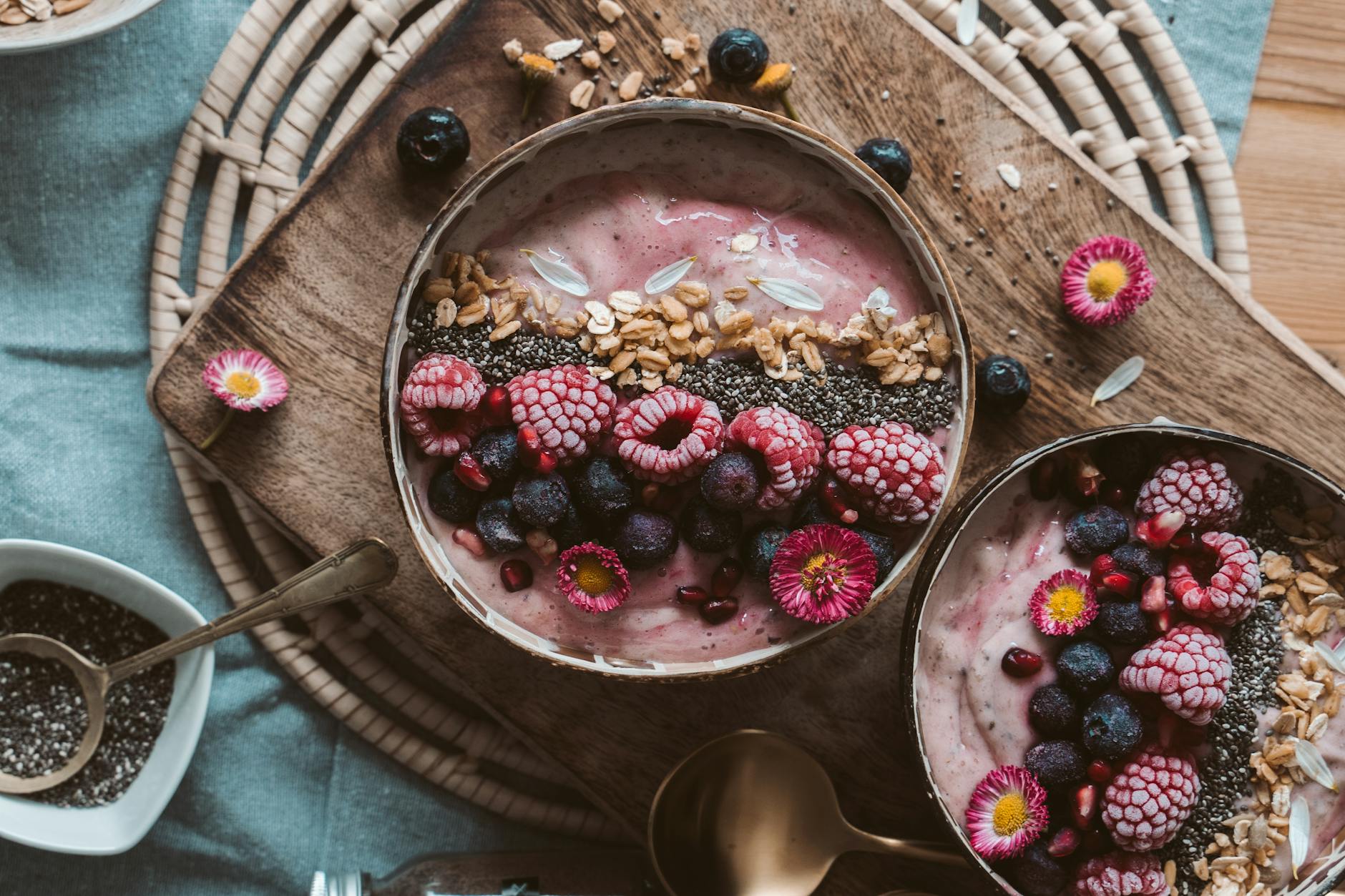 Thick berry smoothie bowl topped with granola and fruit