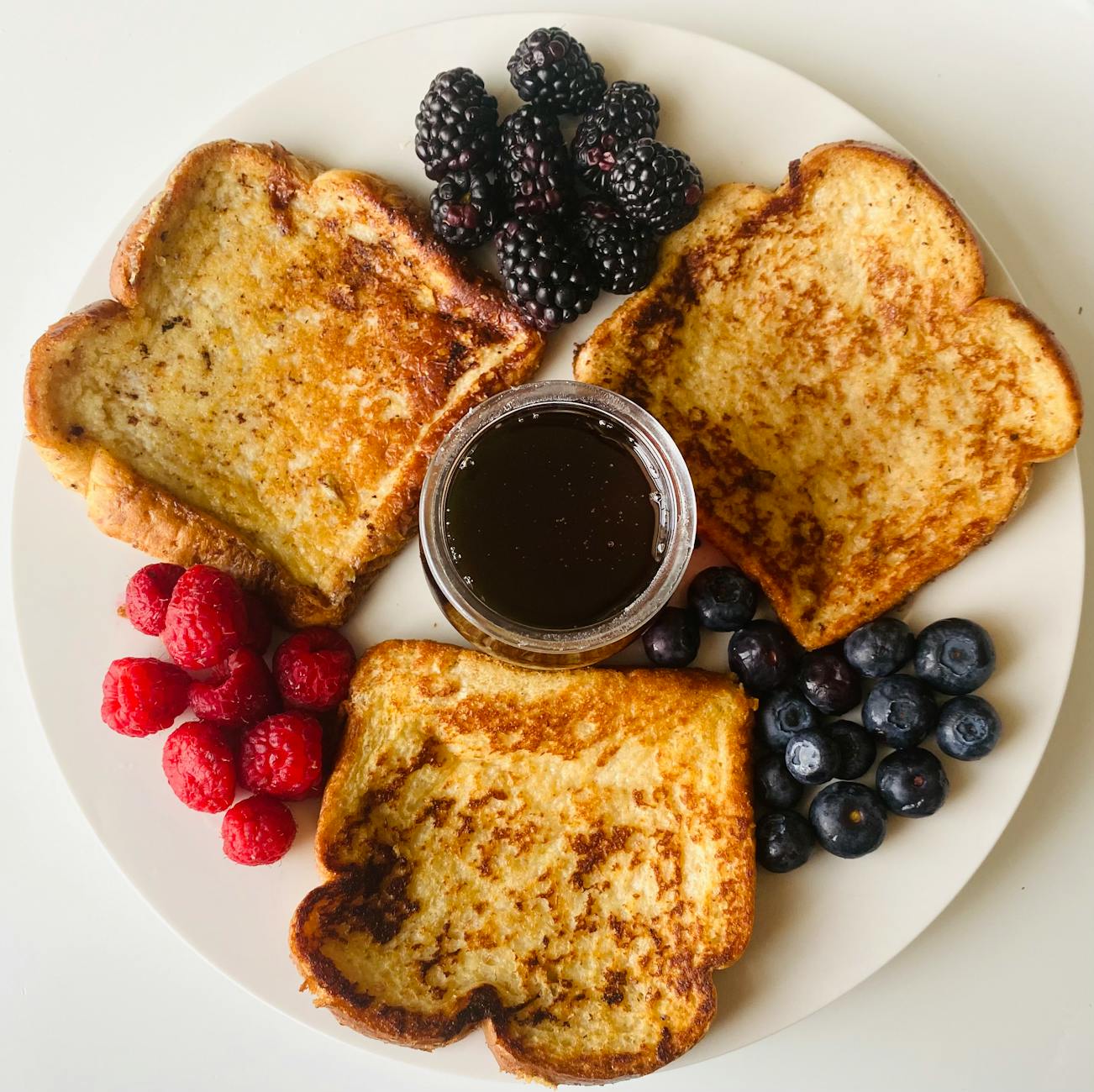 Golden French toast slices with maple syrup and butter