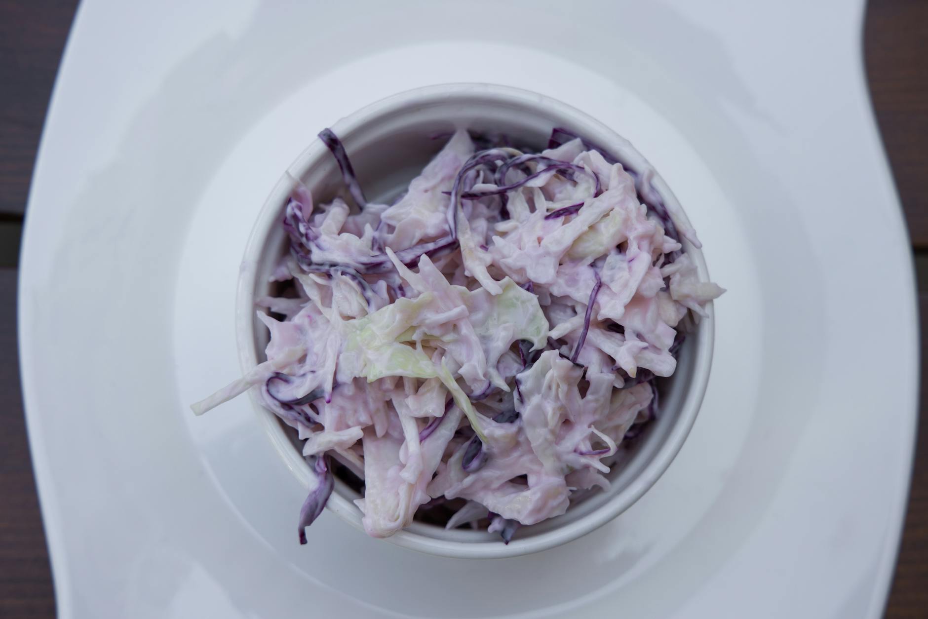 Creamy classic coleslaw in a white serving bowl