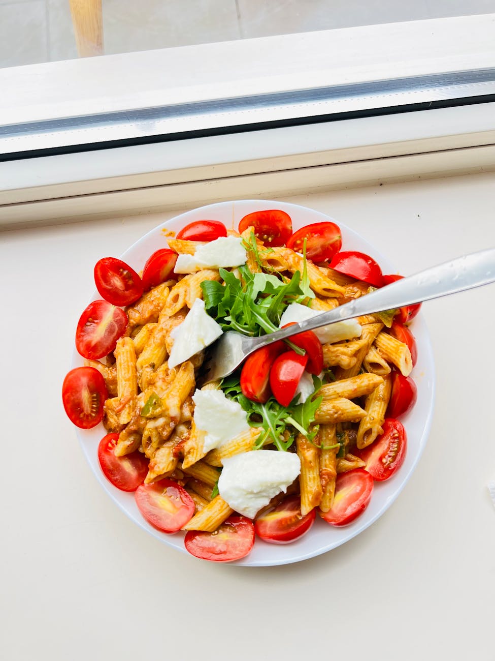 Italian pasta salad with cherry tomatoes and mozzarella