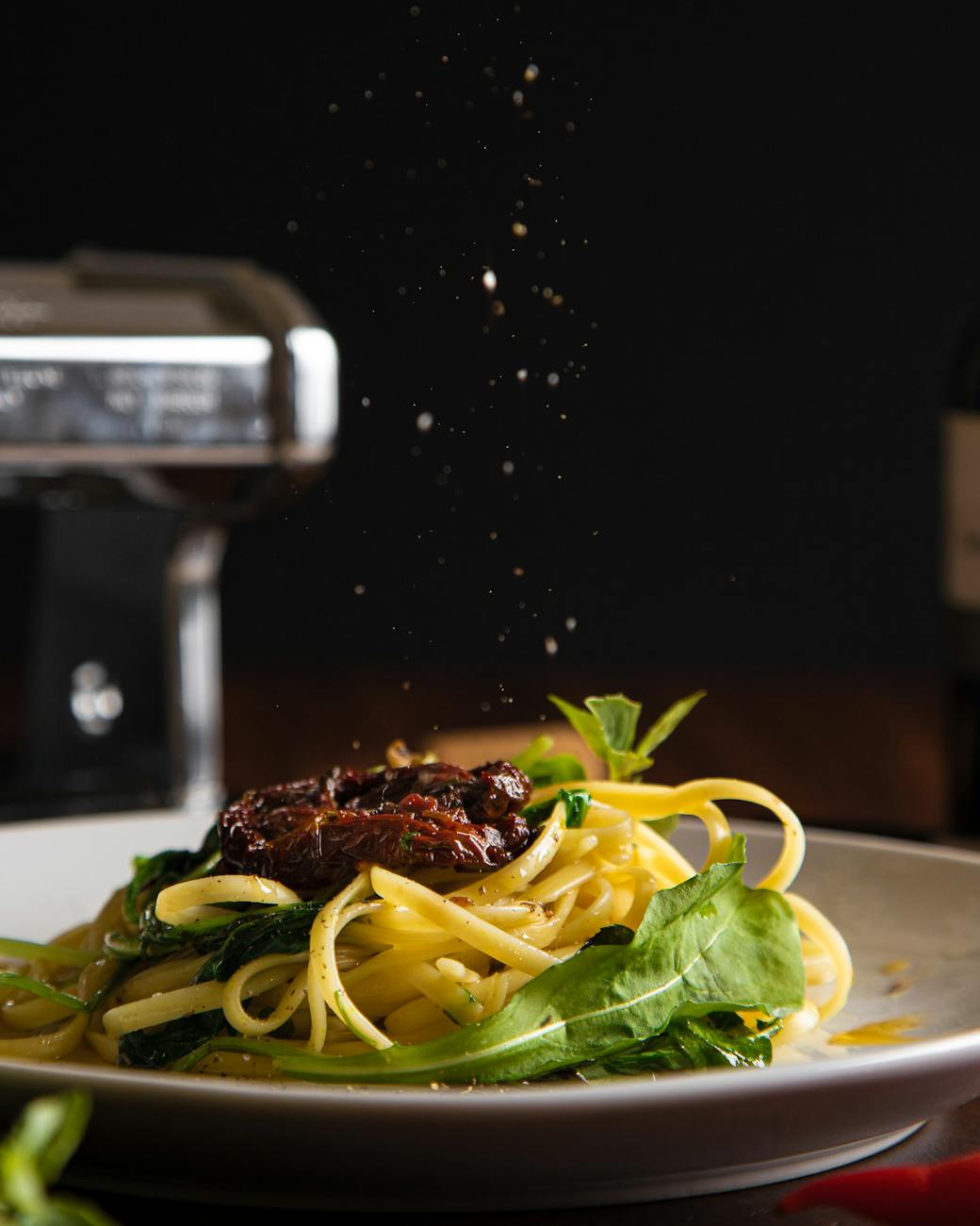 Pasta with sun-dried tomatoes and spinach on a plate