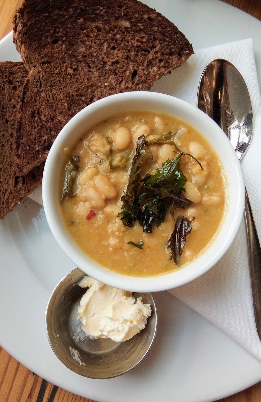 A bowl of white bean soup with a drizzle of olive oil
