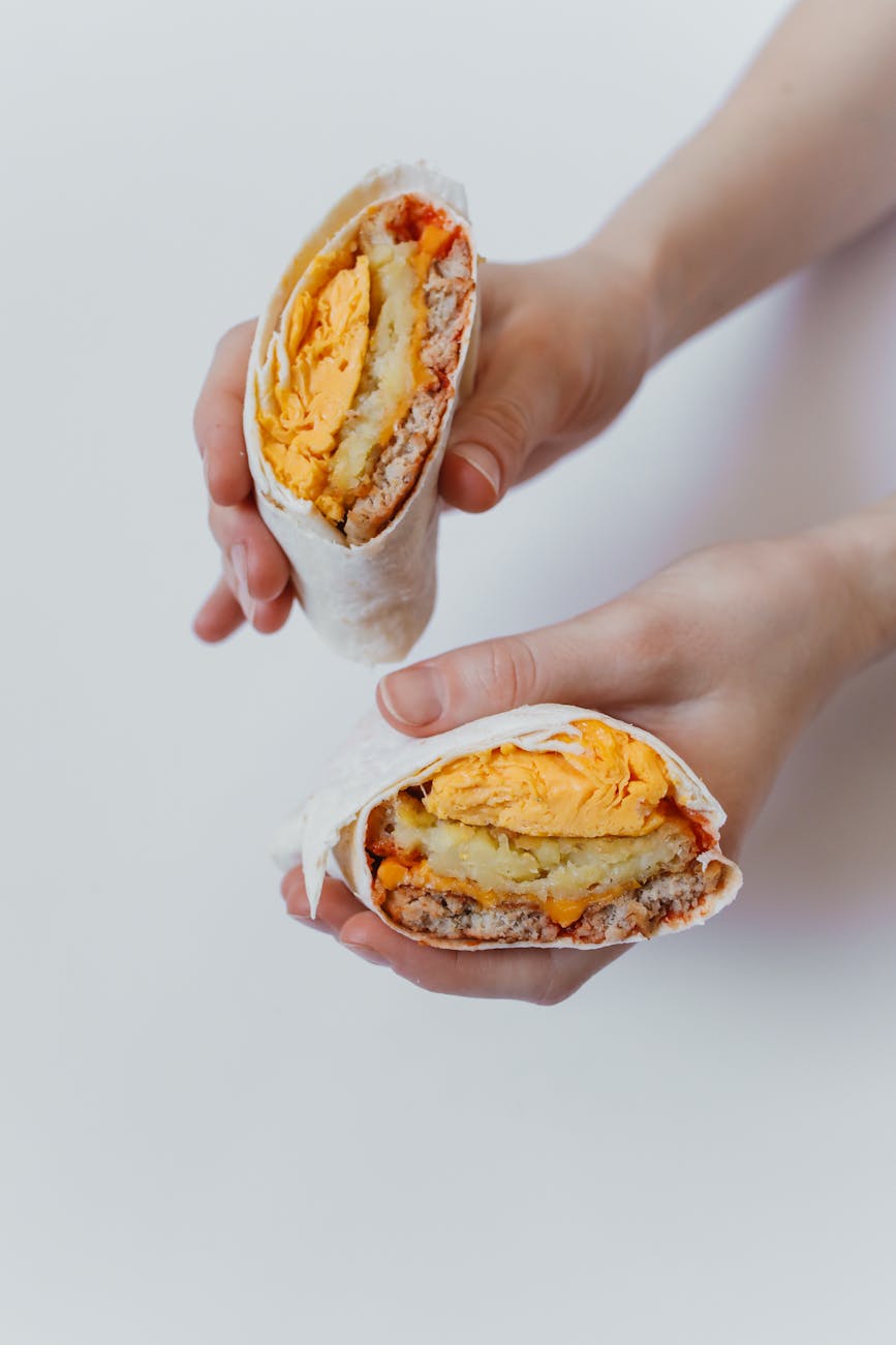 Breakfast burrito halves filled with scrambled eggs and potatoes