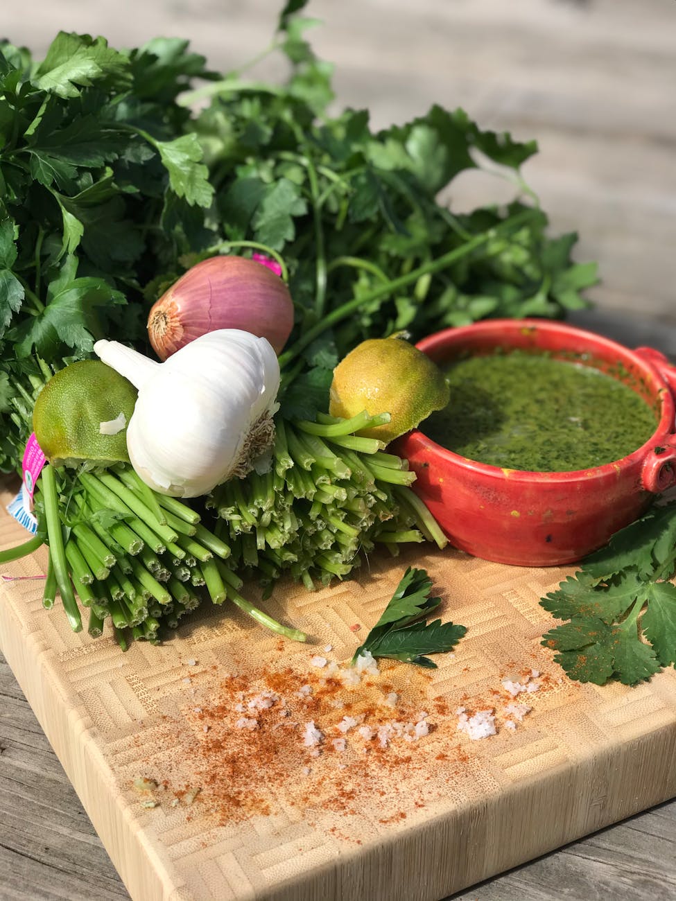 Salsa verde in a bowl with fresh herbs