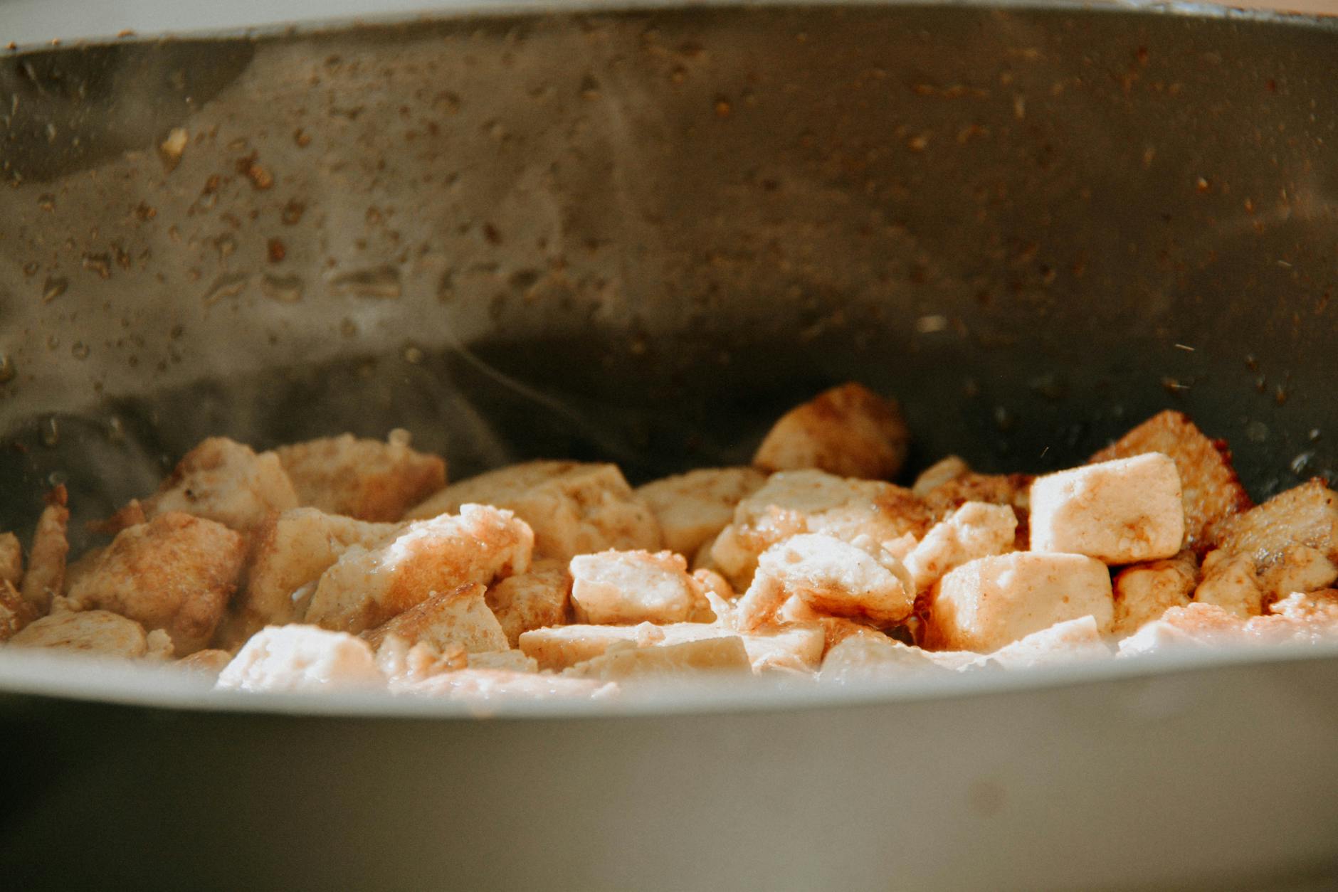 Crispy golden tofu cubes in a pan
