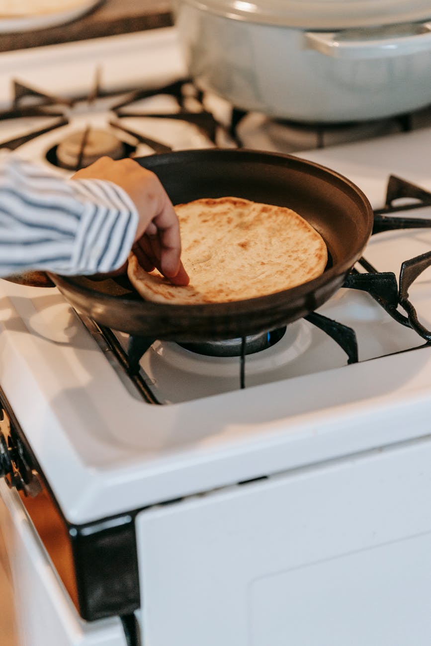 Soft flatbreads with charred spots on a wooden board