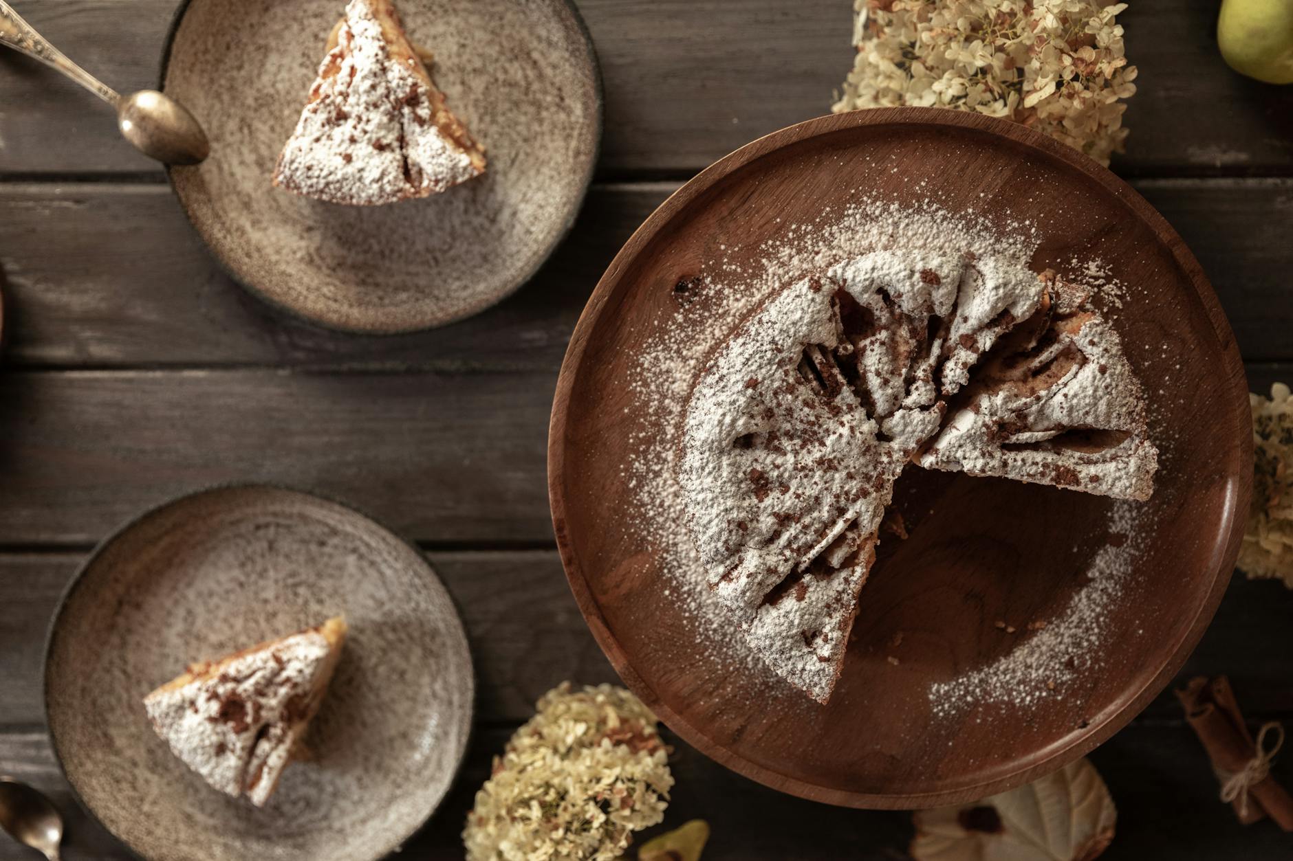 Olive oil cake dusted with powdered sugar on a plate