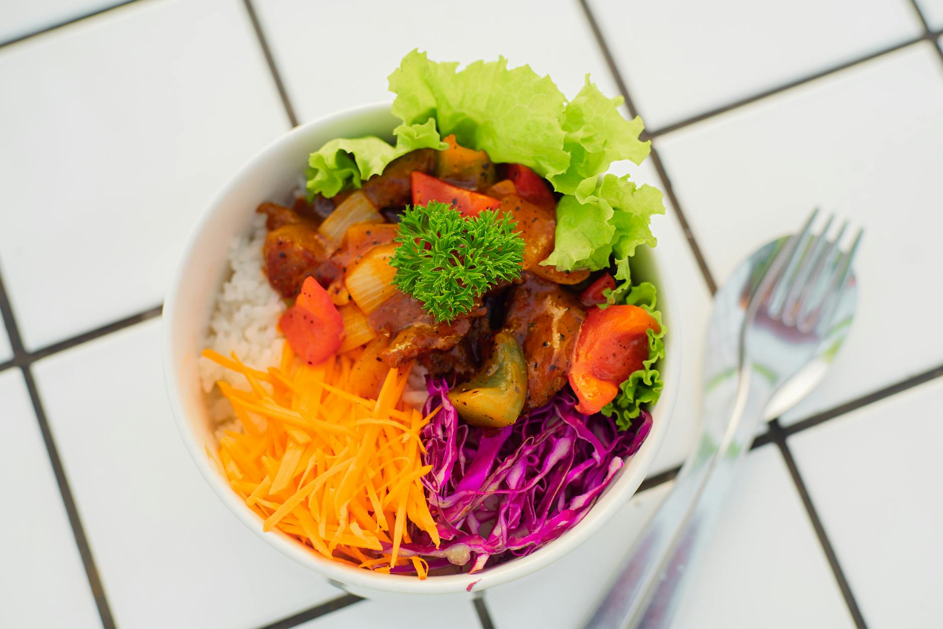 Buffalo chicken and rice in a skillet topped with melted cheese