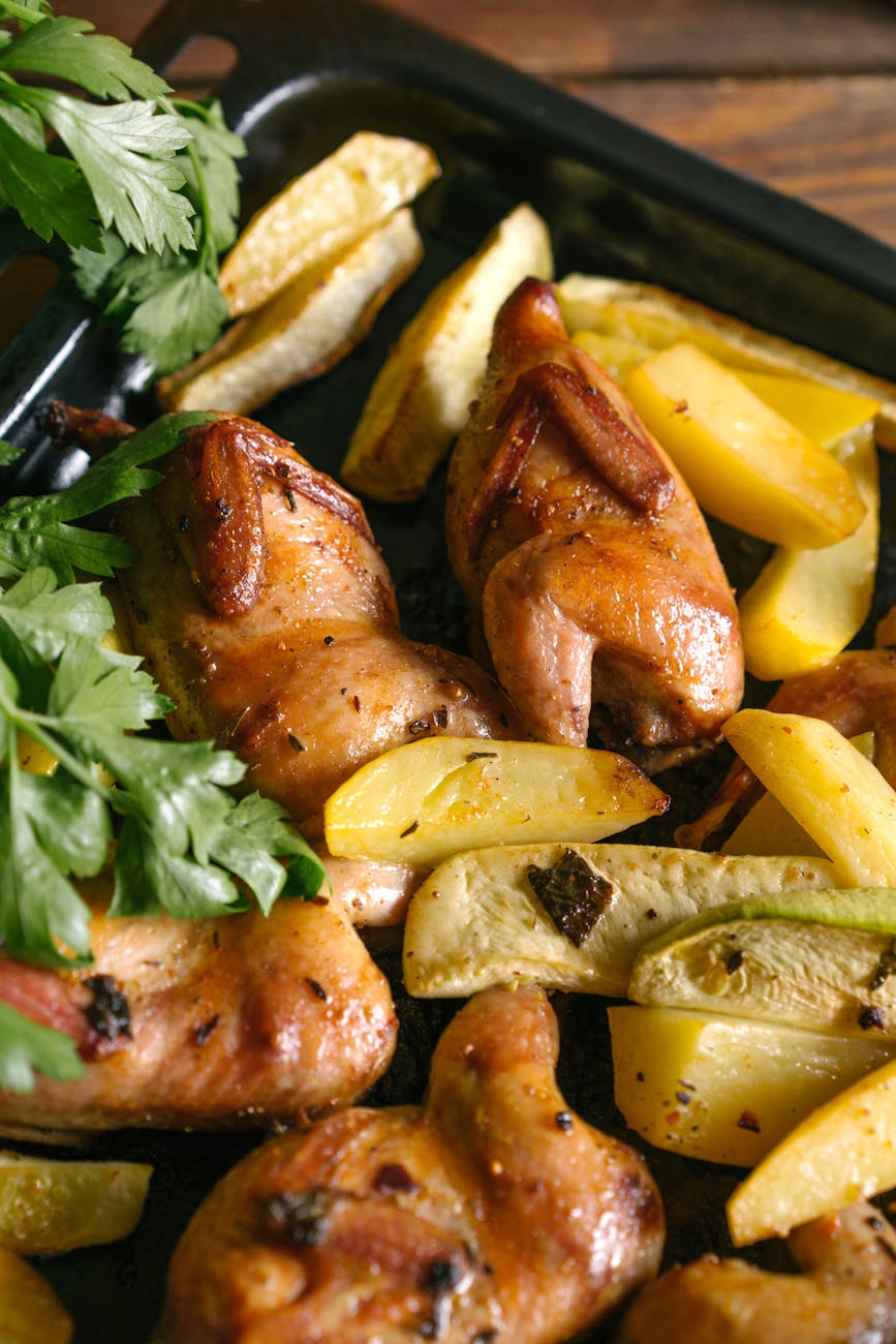 Golden crispy chicken thighs with lemon slices in a cast iron pan