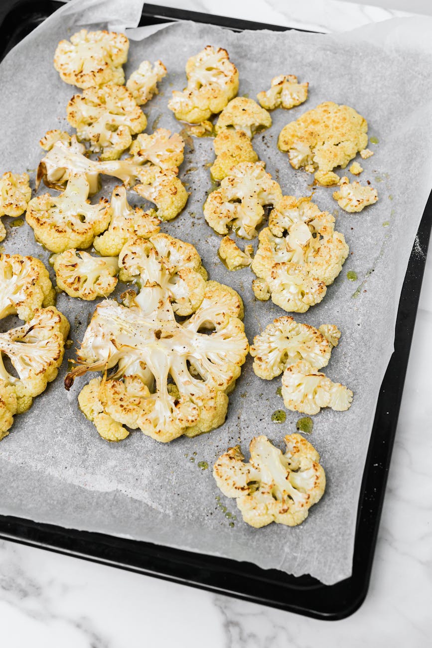 Roasted cauliflower steaks on a sheet pan with golden caramelization