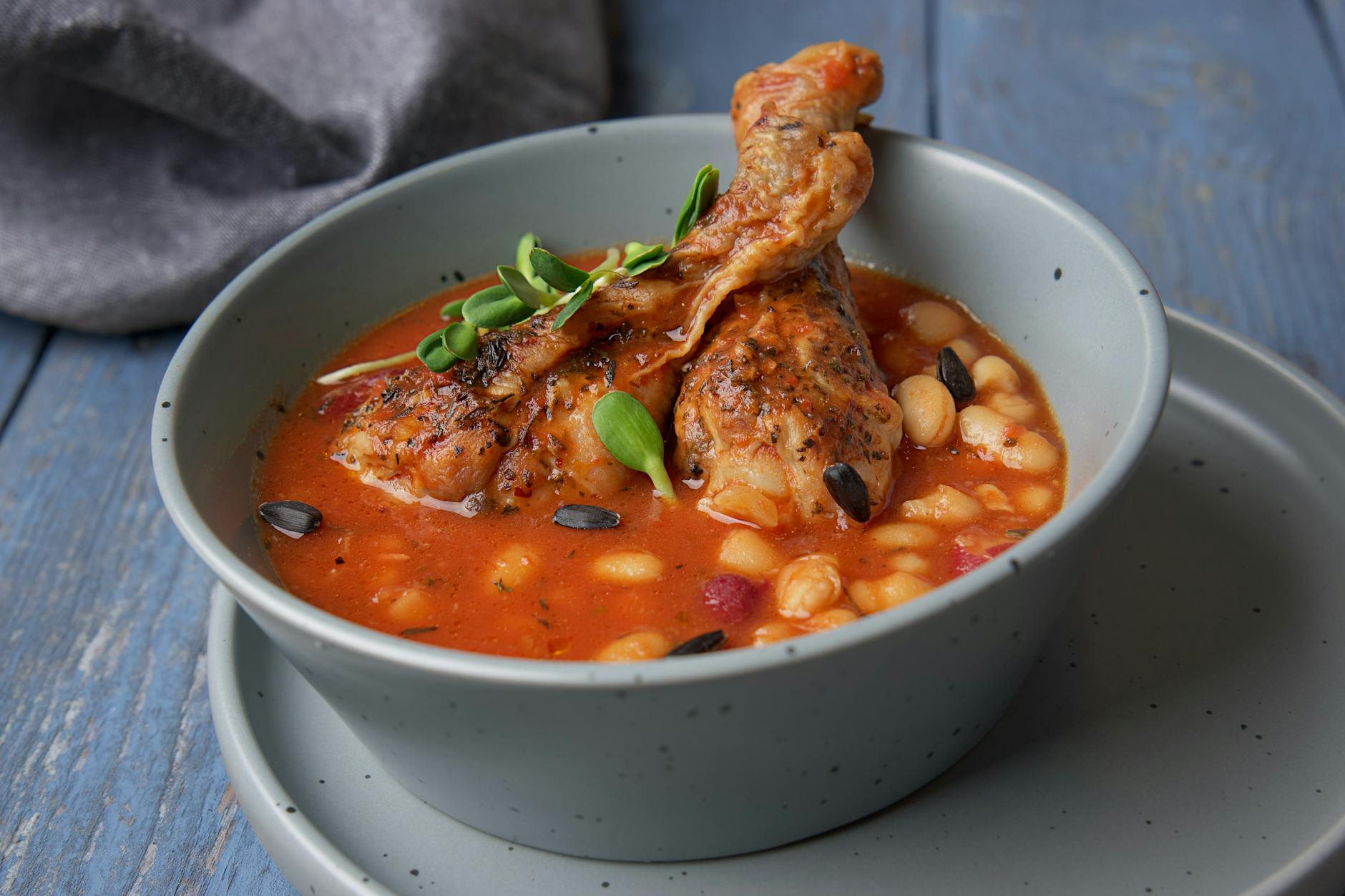 Hearty chicken and bean stew in a ceramic bowl