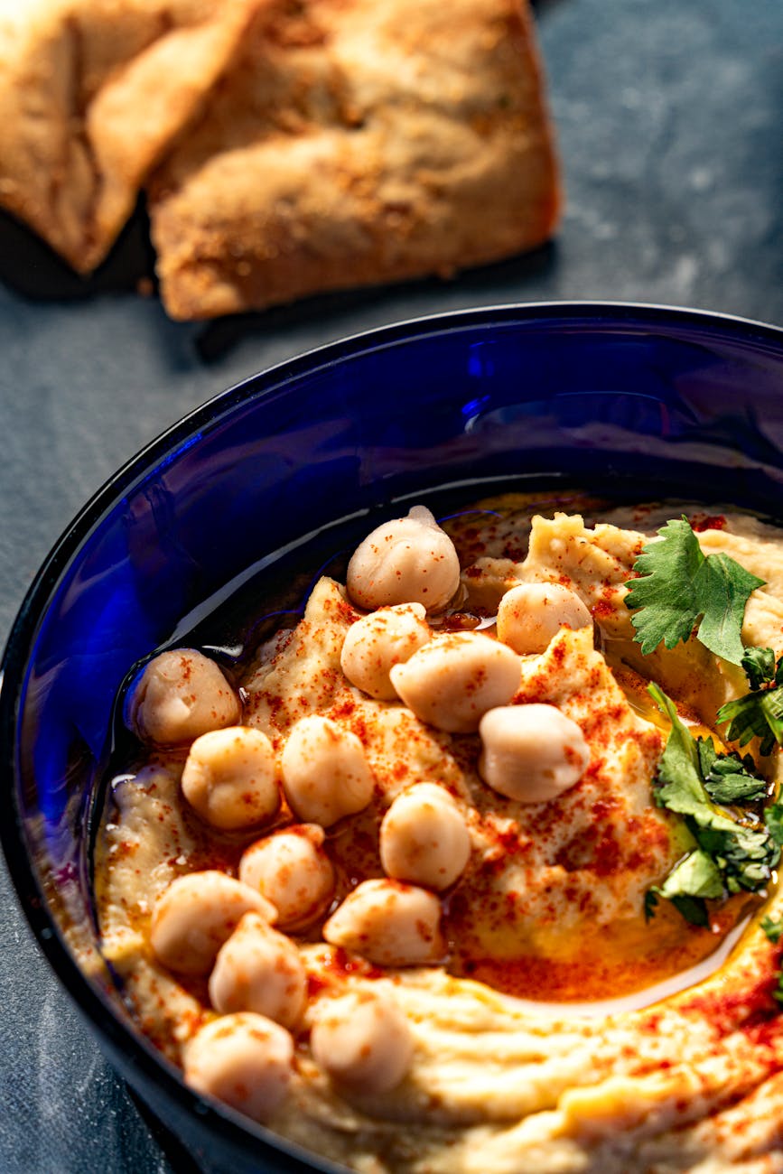 Smooth hummus in a bowl with olive oil and paprika