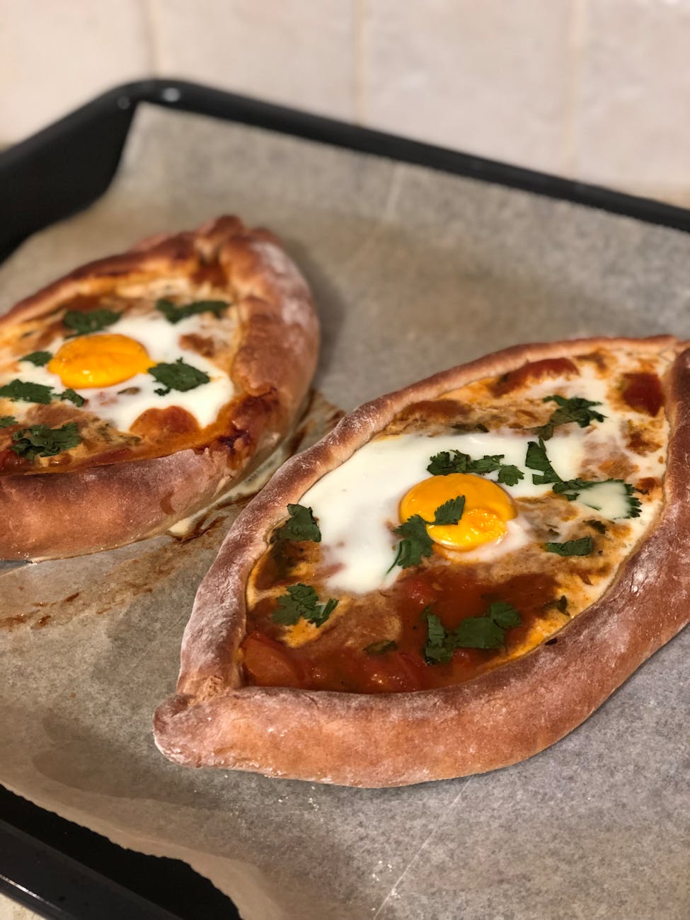 Baked eggs with melted cheese on a sheet pan